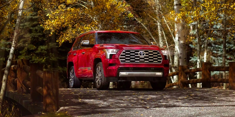 A 2024 Toyota Sequoia driving down a picturesque road near Kent, OH