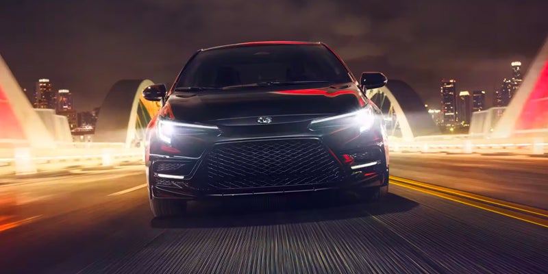 A 2024 Toyota Corolla Hybrid driving at night near Kent, OH