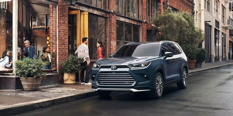 A 2024 Toyota Grand Highlander Hybrid parked outside a cafe in Kent, OH
