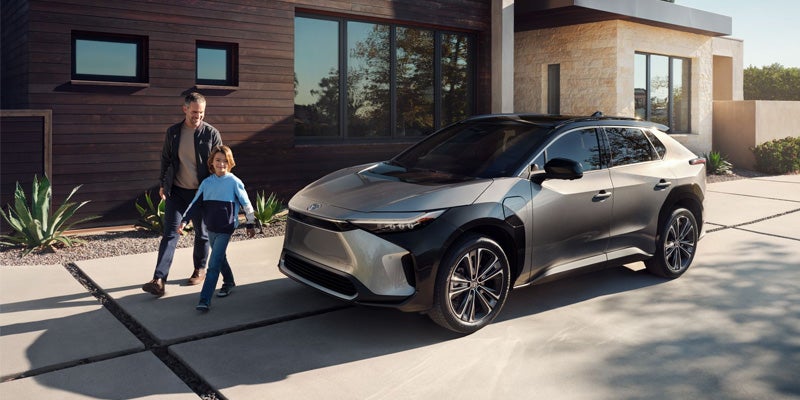 A 2024 Toyota bZ4X parked outside a stylish building near Kent, OH