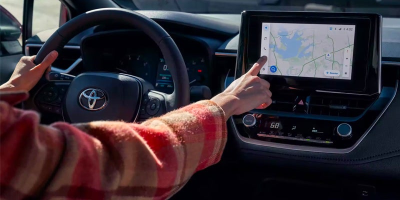 A driver using the safety features in a 2024 Toyota Corolla in Kent, OH